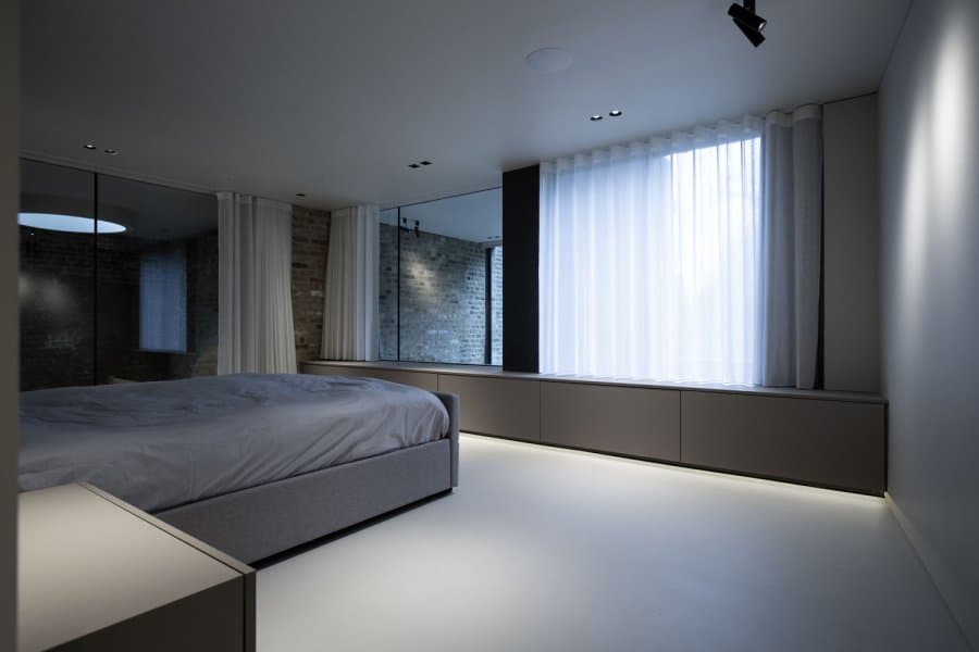 Concealed linear lighting under bedroom joinery at Station House, London