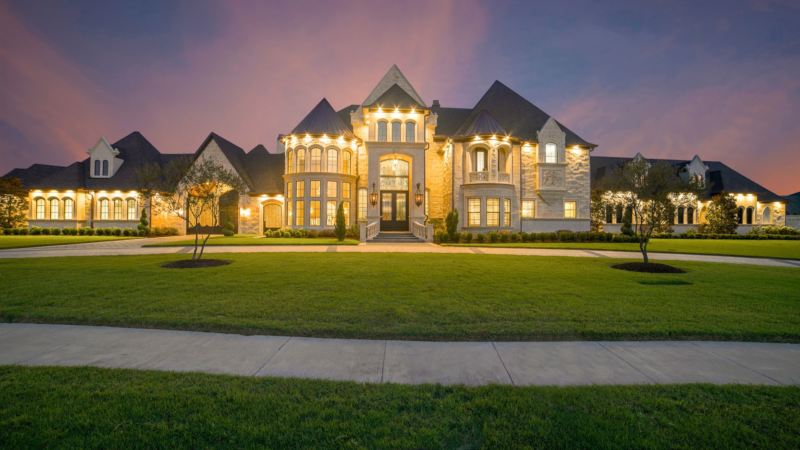 Luxury residence at dusk with warm automated exterior lighting