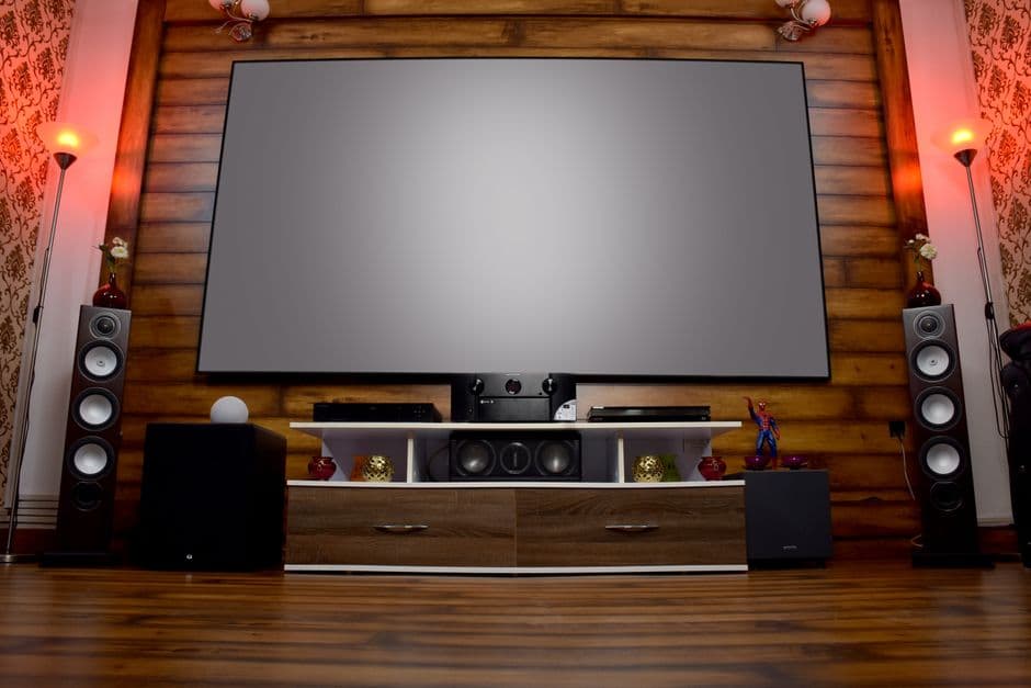A stylish home cinema room with a large screen and audio system