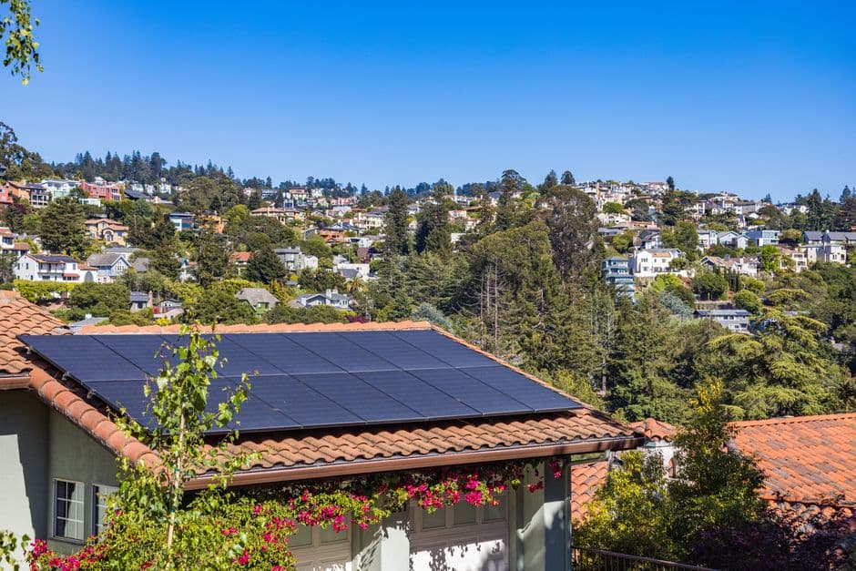 Solar panels on the roof of a suburban house in sunshine
