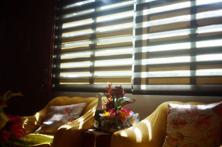 Warm sunlight streaming through window blinds into a seating area